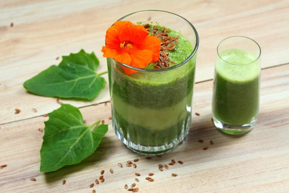 Image of smoothie with nasturtium flower and leaves.