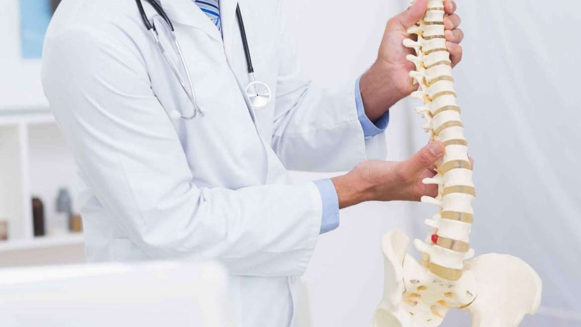 Image of a doctor demonstrating degenerative disc disease to a patient.
